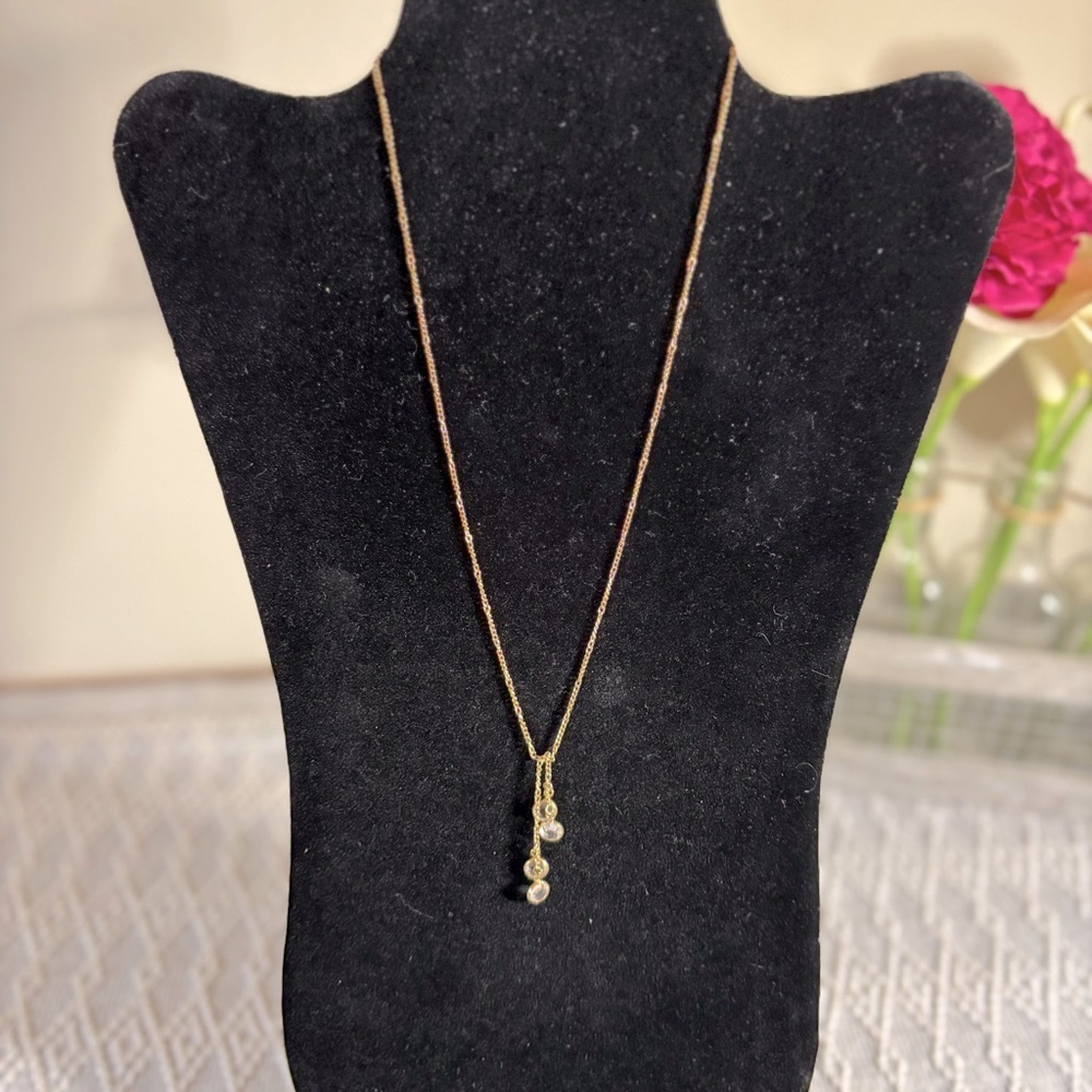 Avon bezeled rhinestone gold toned necklace. 4 stones. Stamped “Avon”. 18”